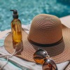 a hat and sunglasses by a pool