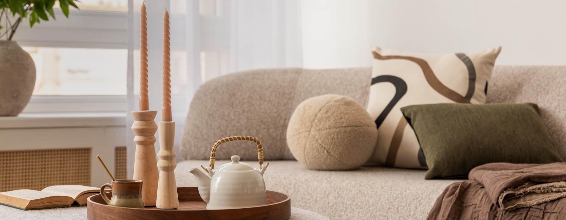 living room with couch coffee table with tea pot and candles on it